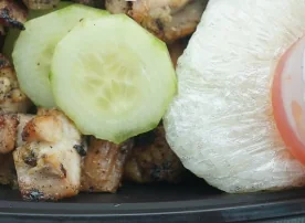 Thai chicken with sticky rice and sliced cucumber
